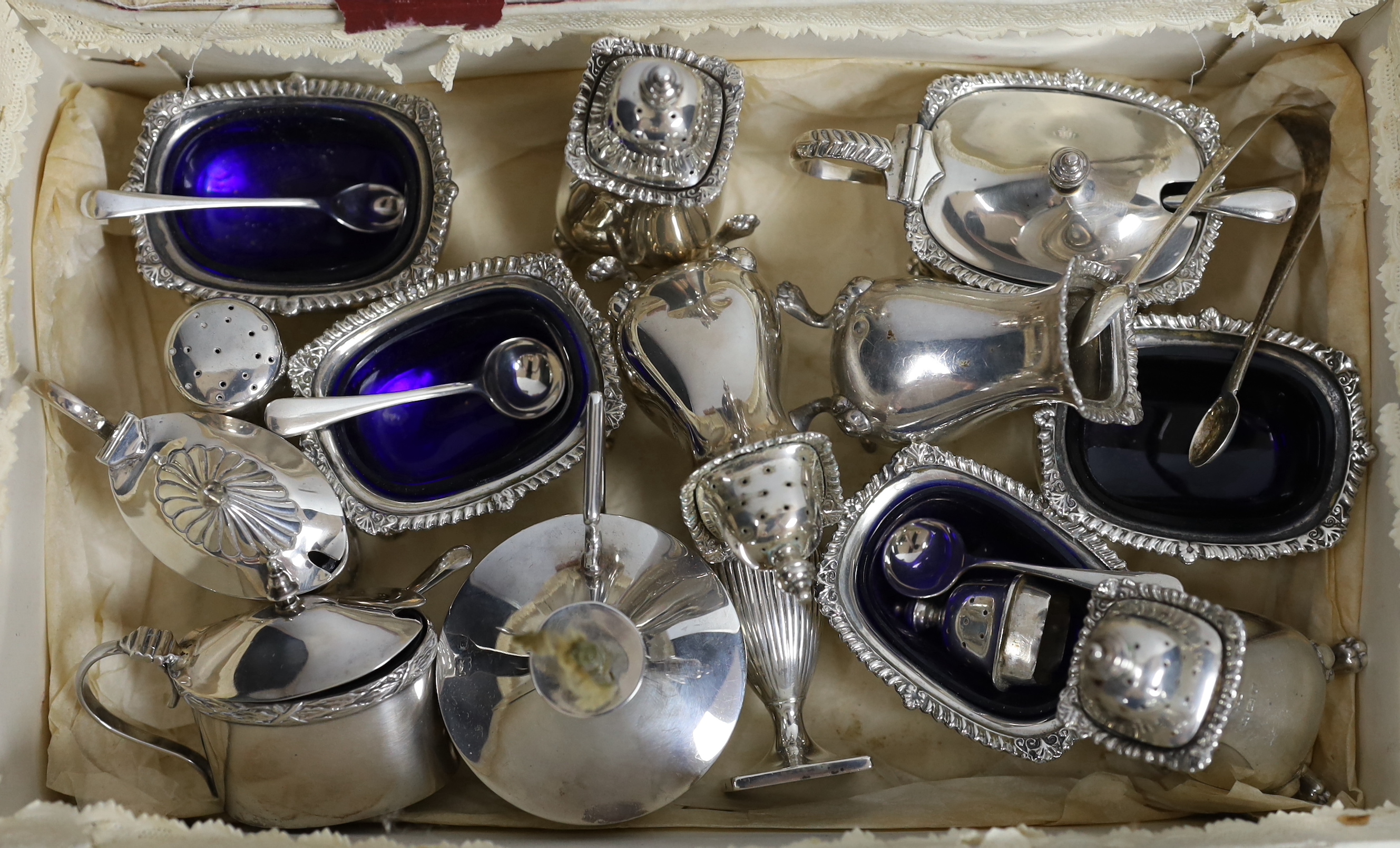 A George V silver nine piece condiment set, by Harrod's Ltd, Birmingham, 1933, a cased three piece silver condiment set and six other items including condiments and a table perpetual lighter.